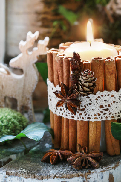 Candle decorated with cinnamon sticks - Фото, зображення