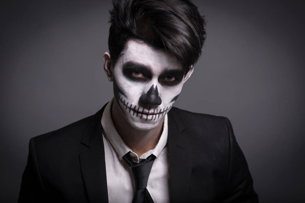 Skull make up portrait of young man in studio. - 写真・画像