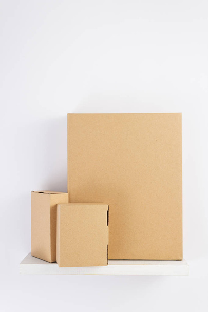 cardboard box on wooden shelf  - Фото, изображение