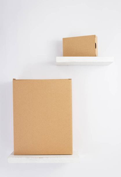 cardboard box on wooden shelf  - Foto, Imagem