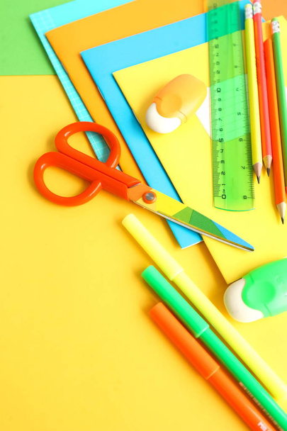 Back to school background. School supplies bright colors at abstract colored background. Education concept. Top view. Copy space - Photo, Image