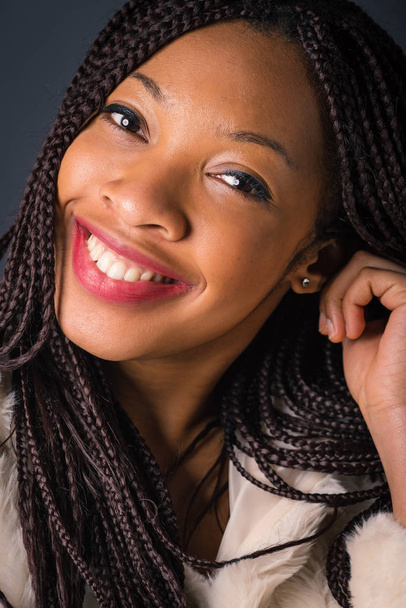 Smiling African young woman close up studio portrait with braids - Fotoğraf, Görsel