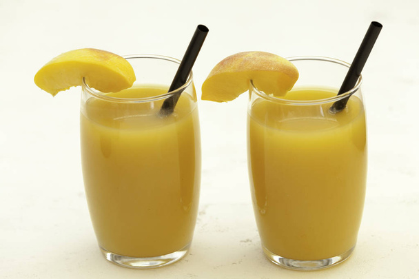  peach juice glasses on white table  backdrop  - Photo, Image