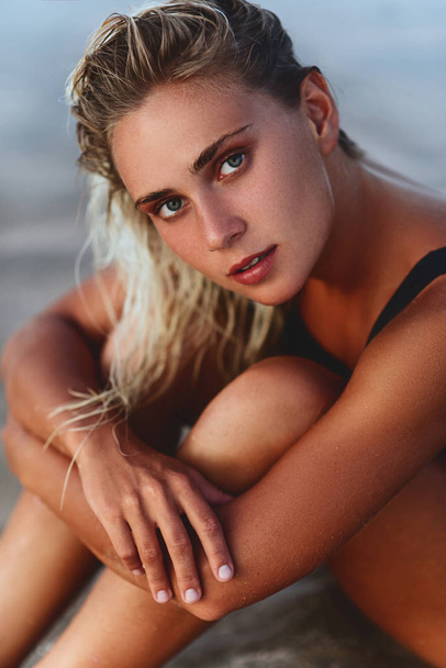 Closeup portrait of attractive blonde girl with long hair posing on beach. - Φωτογραφία, εικόνα