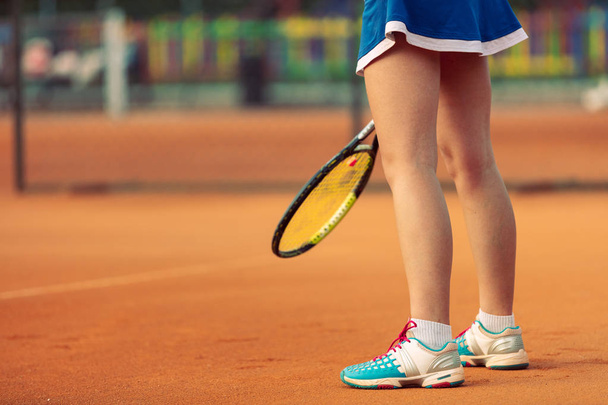 Beautiful female athlete with perfect body posing on tennis court, close up - Фото, зображення