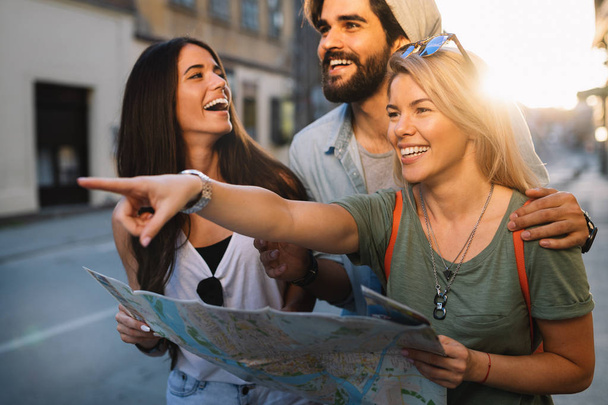 Friendship, travel, vacation, summer and people concept. Group of smiling friends traveling - Photo, Image