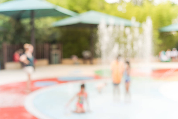 Blurry background diverse children playing at water splash pad in Houston, Texas - Photo, Image
