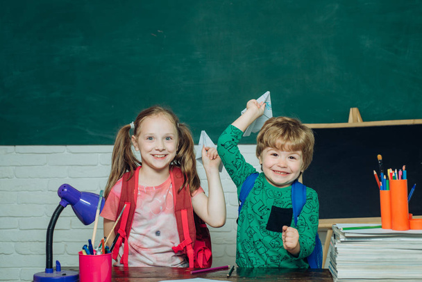 Back to school. Kids gets ready for school. Funny little child having fun on blackboard background. Teachers day. - Фото, изображение