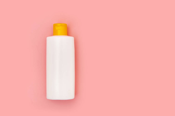 blank white squeeze bottle plastic tube on pink background copy space - Fotó, kép