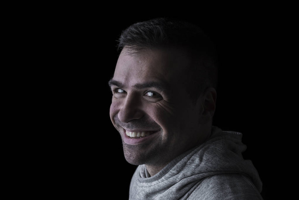 Portrait of a smiling man. Isolated. Black background. Horizontal. Copyspace. - Photo, Image