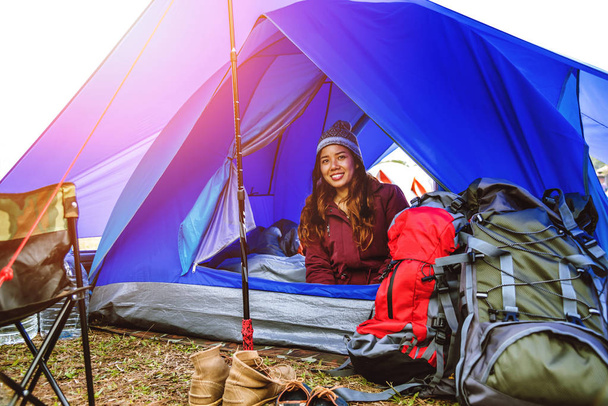 Asian women travel relax in the holiday. camping on the Mountain. The young woman travels nature. Travel relax. Tourist overnight camp on the mountain. camping tent, camping Thailand. women travel countryside.  travel Thailand. - Photo, Image