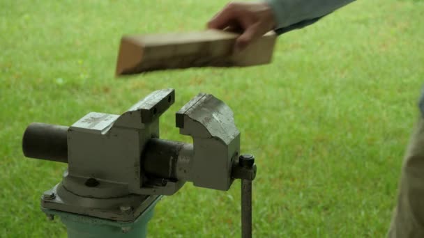 Hand gripe. Vice. Clamping the workpiece. Close-up. Green background - Footage, Video