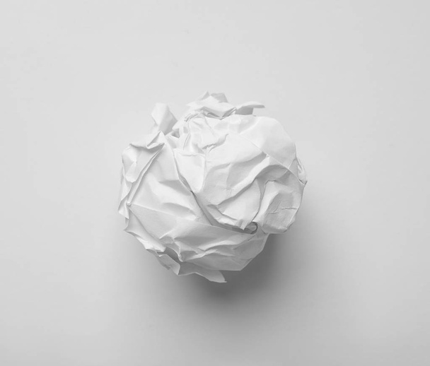Crumpled sheet of paper on white background, top view - Foto, Bild