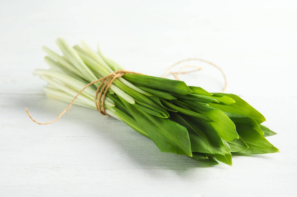 Bunch of wild garlic or ramson on white wooden table, closeup - Foto, immagini