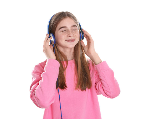 Teenage girl enjoying music in headphones on white background - Foto, Imagem