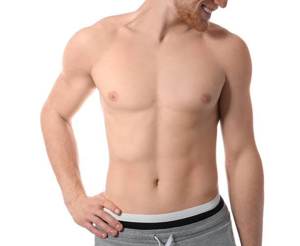 Young man with slim body on white background, closeup - Fotografie, Obrázek