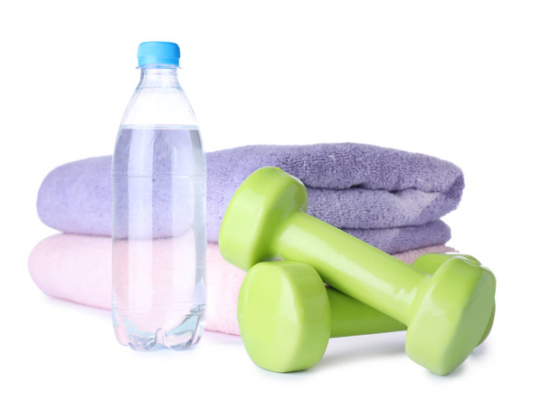 Stylish dumbbells, bottle of water and towels on white background. Home fitness - Fotografie, Obrázek