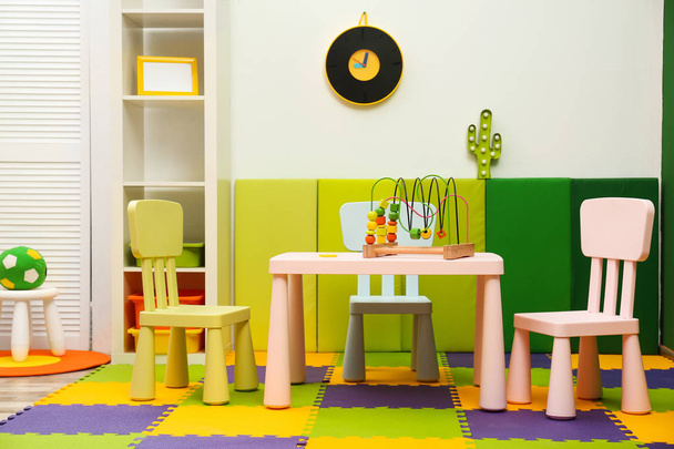 Stylish playroom interior with table and chairs - Fotó, kép
