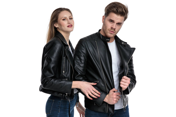 Confident man arrangeing his jacket and posing with his girlfrie - Photo, Image