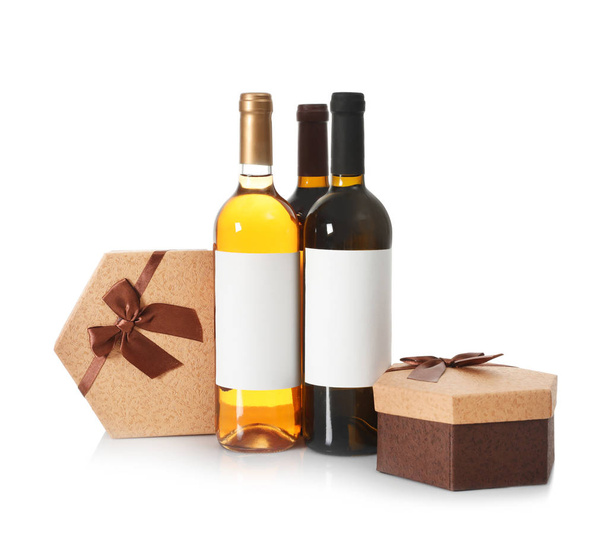 Bottles of wine and gift boxes on white background - Zdjęcie, obraz