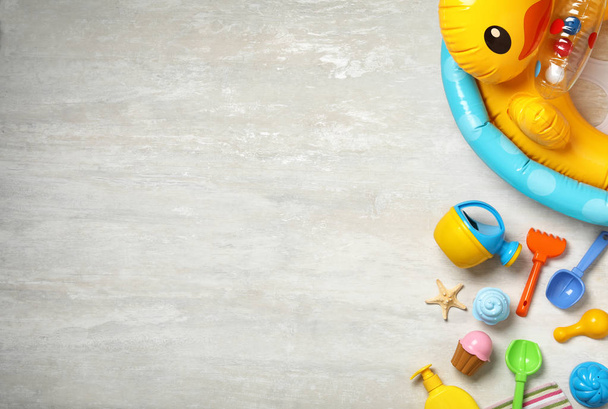Flat lay composition with beach toys on light background. Space for text - 写真・画像