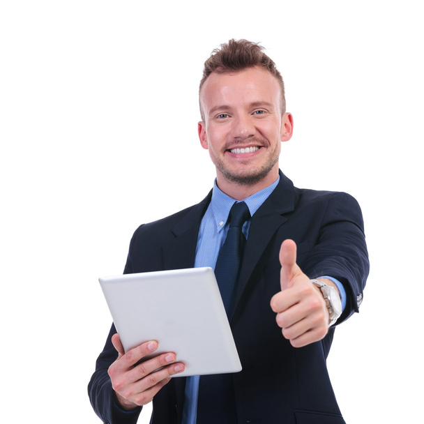 business man holds tablet and shows thumb up - Fotó, kép
