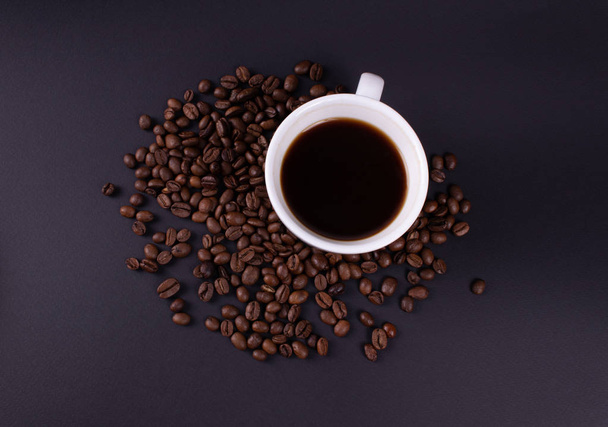 A cup of fresh brewed coffee with coffee beans photo from above - Photo, Image