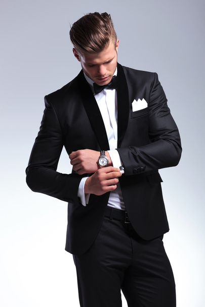 business man looks at his cufflinks - Photo, Image