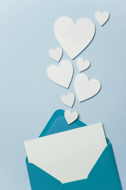 Fathers Day card mockup. Blue envelope blank white card and hearts - Photo, Image