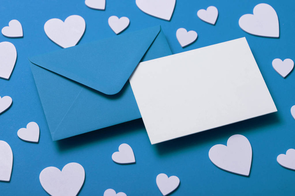 Fathers Day card mockup. Blue envelope blank white card and hearts - Фото, зображення