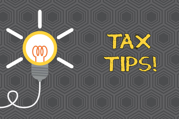 Writing note showing Tax Tips. Business photo showcasing compulsory contribution to state revenue levied by government Idea light bulb Successful turning idea invention Startup. - Photo, Image