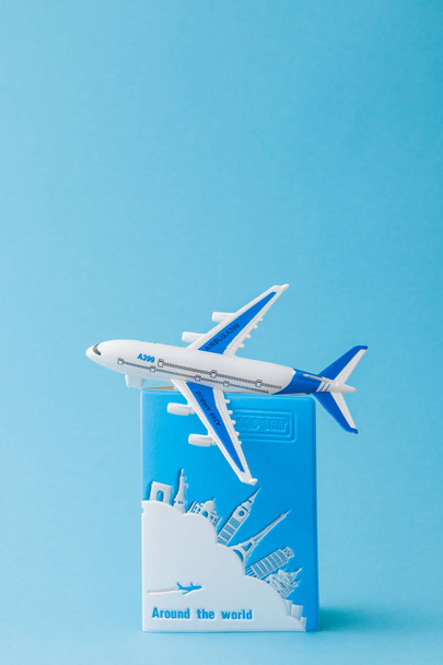 Passport and airplane on a blue background. Travel concept, copy - Fotografie, Obrázek