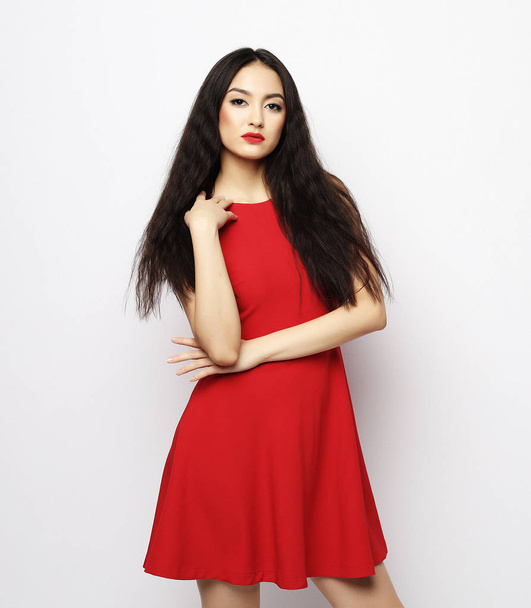 lifestyle and people concept - Young beautiful asian woman wearing red dress - Foto, afbeelding