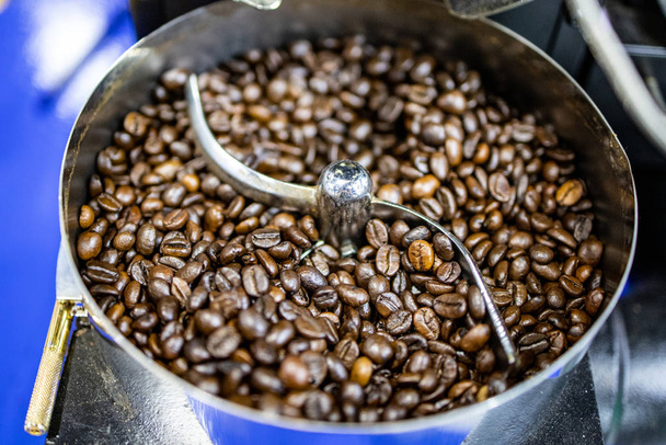 Coffee bean roast in automatic machine without people. Focus and blur some of coffee bean dark roast. - Photo, Image