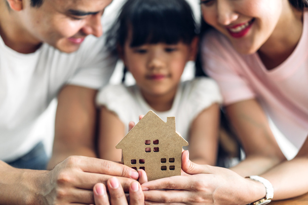 Happy family holding  house in hands.real estate concept - Photo, Image