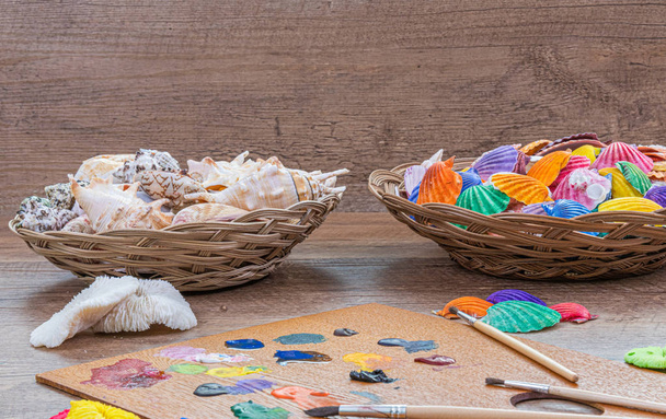 Beautiful composition of painted sea shells and wood background . Abstraction, sea theme, nature, travel, science, beauty. - Photo, Image