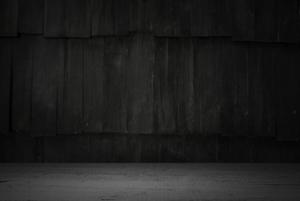 Mesa de madera vieja con la pared borrosa del bloque de hormigón en fondo oscuro de la habitación
. - Foto, imagen
