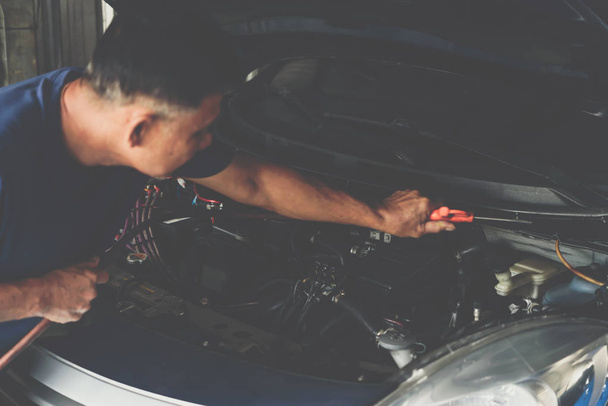 Checking a car engine for repair at car garage - Photo, Image