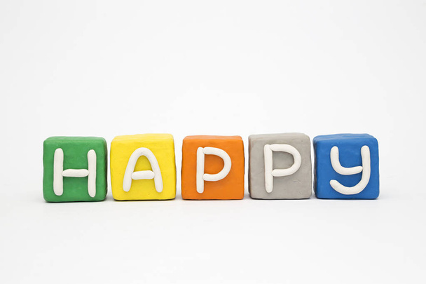 The word "Happy" on the clay colorful blocks - Φωτογραφία, εικόνα