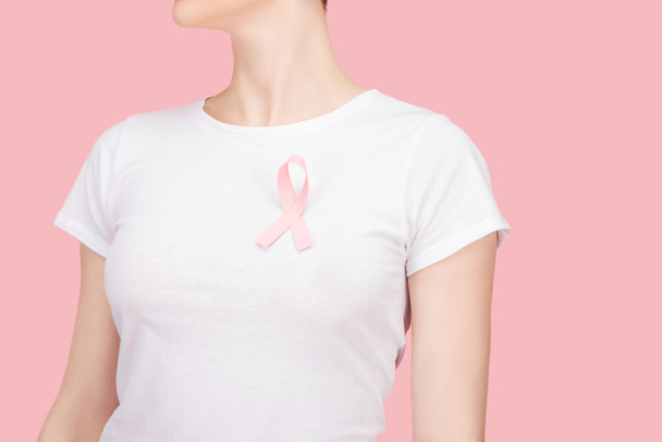 cropped view of woman with pink breast cancer sign isolated on pink - Fotoğraf, Görsel