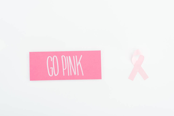 top view of pink breast cancer sign and card with go pink lettering on white background - Fotó, kép