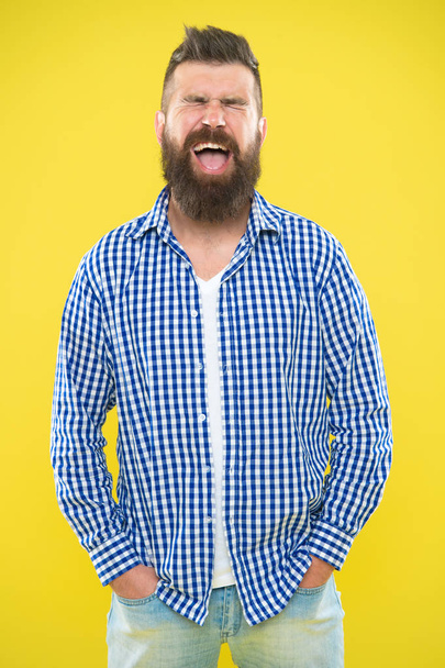 Emotional man with beard on yellow backdrop. Brutal bearded hipster in checkered shirt. Summer hipster. Male fashion spring style. Mature happy man. positive emotions. feeling and emotions concept - 写真・画像