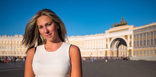 Young beautiful woman close up portrait outdoor in Palace square in a sunny day. Real lifestyle moment captured. Saint Petersburg, Russia. - Fotografie, Obrázek