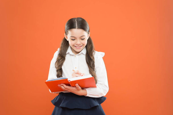 Schoolgirl enjoy study. Kid school uniform hold workbook. School lesson. Child doing homework. Your career path begins here. Write essay or notes. Inspiration for study. Back to school. Knowledge day - Foto, Imagen