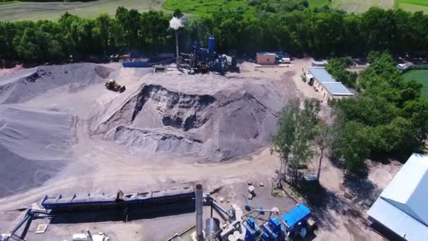 Asphalt plant territory. Flue pipe of the enterprise. Large mounds of building material. Aerial drone footage. - Imágenes, Vídeo