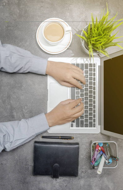Top view of businessman working using laptop with coffee, potted - Zdjęcie, obraz