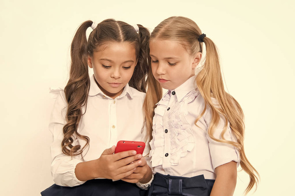 Little children depend on mobile phone. Girls text sms with mobile phone. depend. - Foto, Bild