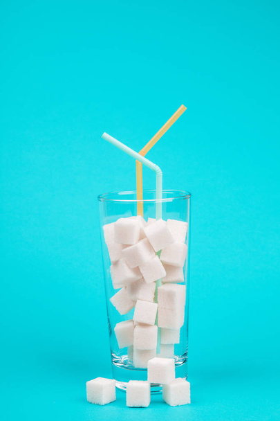 Glass of sugar. The concept of junk food. On red background. - Фото, зображення