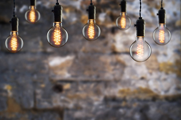 Idea and teamwork concept Vintage  bulbs on wall background - Photo, Image