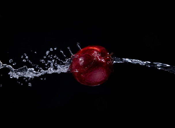 red apple splash on black background - Photo, Image
